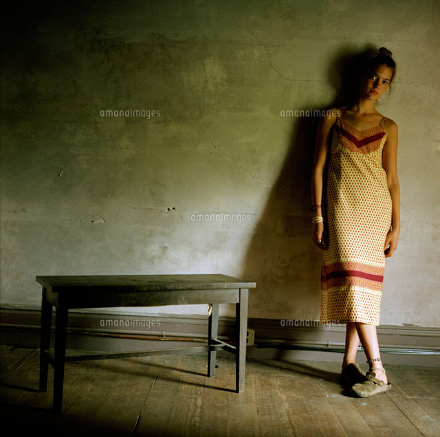 A woman stands with her legs crossed
(c)fStop