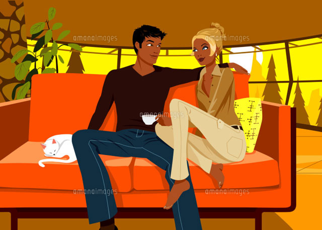 Man and woman and cat sitting on sofa
(c)Greg Paprocki