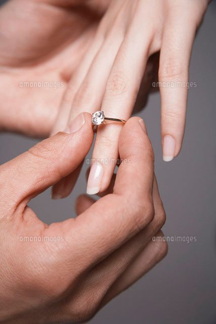 Man placing engagement ring on womans finger close-up of
(c)moodboard