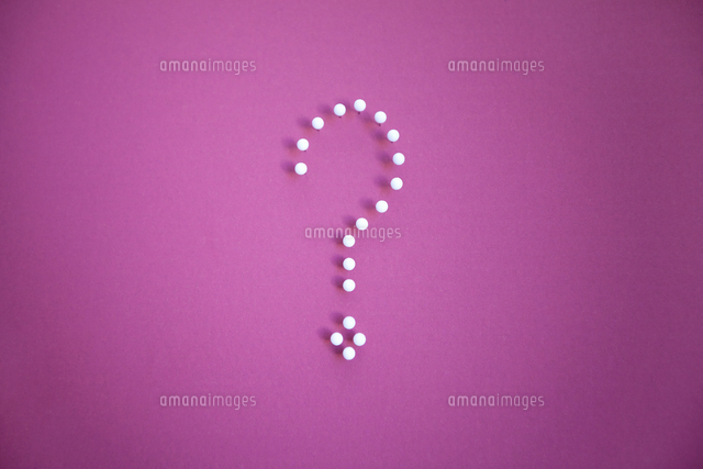Close-up of push pins forming question mark over pink backgr
(c)moodboard