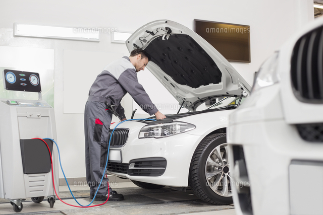 Full length of male engineer examining car in automobile repair shop
(c)moodboard