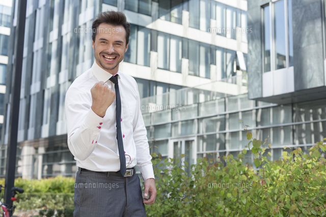Portrait of happy businessman with clenched fist standing outside office building
(c)moodboard