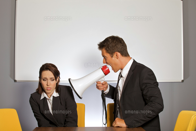 Businesswoman shouting at businessman through megaphone
(c)moodboard