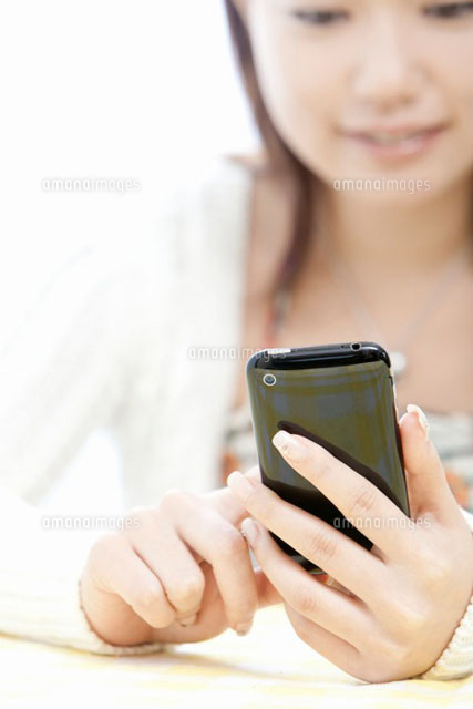 スマートフォンを触る若い女性
(c)iconics
