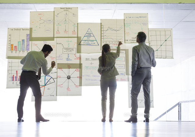 Business people working with charts and graphs on glass wall
(c)caiaimage
