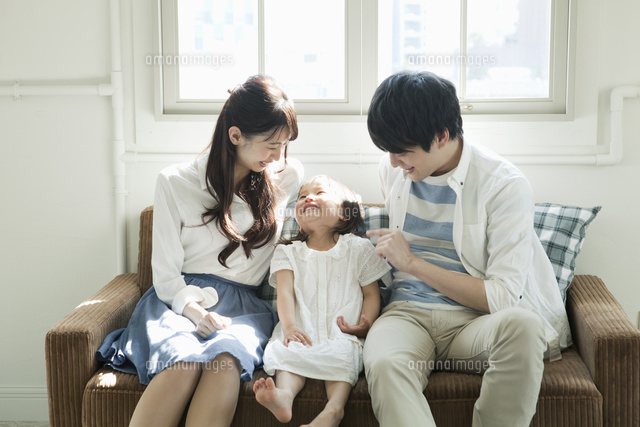 部屋でくつろぐ若い夫婦と子供
(c)absodels RF