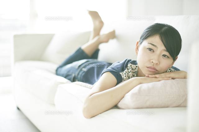 ソファーに寝転びながら何か思いふけっている女性
(c)SHAKTI/a.collectionRF