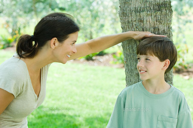 mother placing her hand on son’s head
(c)Odilon Dimier/Photo Alto