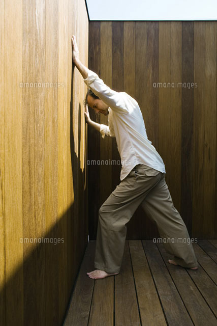 Man leaning against wall, arms raised
(c)Sandro Di Carlo Darsa/Photo Alto