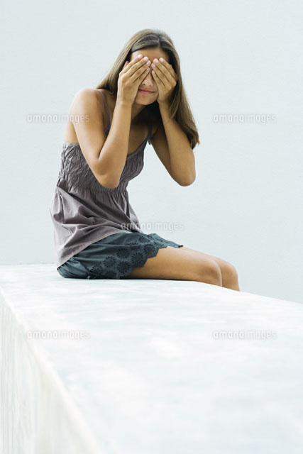 girl sitting, covering eyes with hands
(c)Sandro Di Carlo Darsa/Photo Alto
