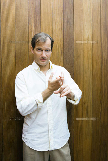 Man standing & making gesture with hands
(c)Sandro Di Carlo Darsa/Photo Alto