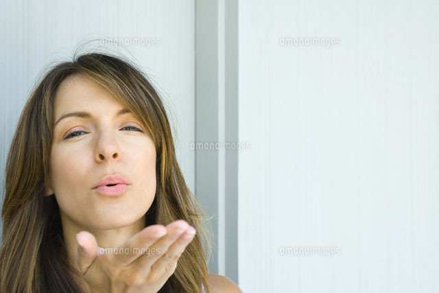 Woman blowing kiss at camera
(c)Sandro Di Carlo Darsa/Photo Alto