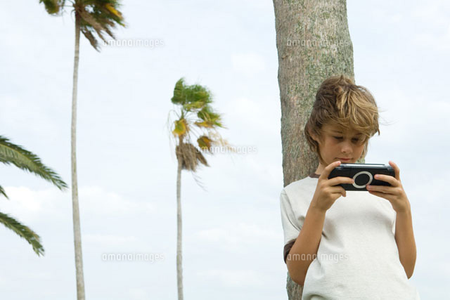 Boy playing handheld video game
(c)Eric Audras/Photo Alto