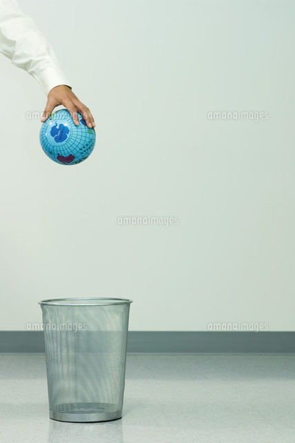 Businessman holding globe over trash can
(c)Milena Boniek/Photo Alto