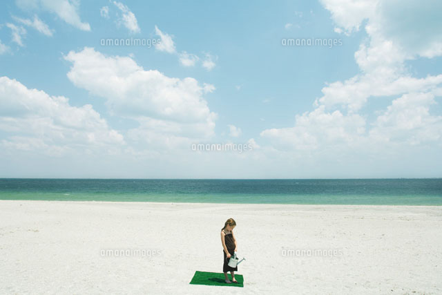 Girl watering square of artificial turf
(c)Milena Boniek/Photo Alto