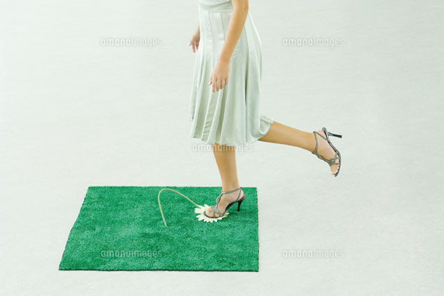 Woman stepping on flower
(c)Milena Boniek/Photo Alto