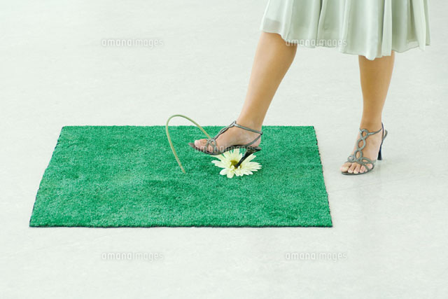Woman sticking heel into flower
(c)Milena Boniek/Photo Alto