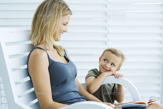 Woman sitting in chair next to son
(c)Laurence Mouton/Photo Alto
