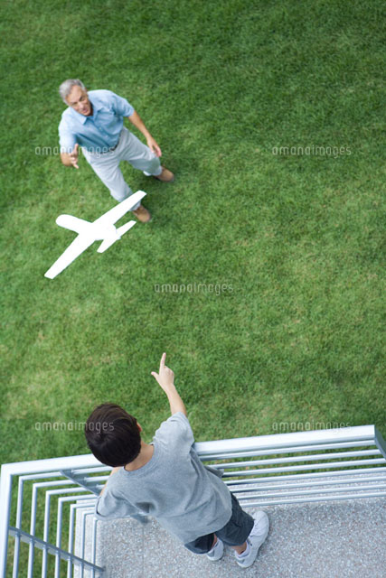 Boy throwing toy airplane to grandfather
(c)Laurence Mouton/Photo Alto