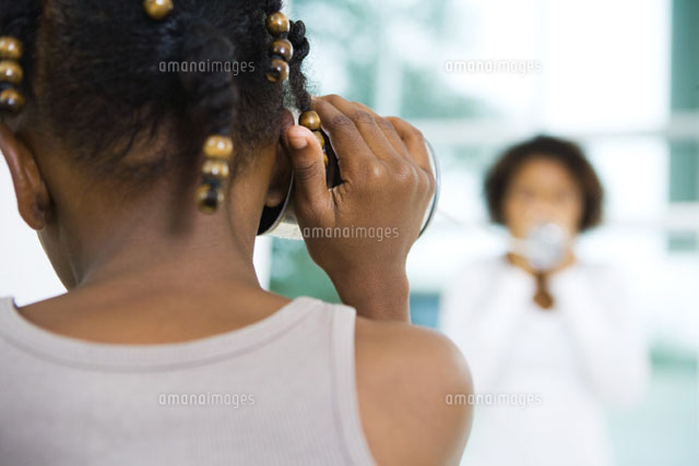 girl holding tin can phone up to ear
(c)Laurence Mouton/Photo Alto
