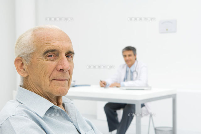 Doctor working at desk, focus on senior patient
(c)Odilon Dimier/PhotoAlto