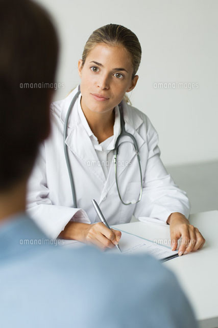 Doctor writing at desk, patient in foreground
(c)Odilon Dimier/PhotoAlto