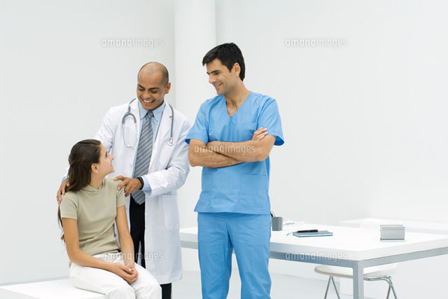 Doctor standing with hands on teen girl’s shoulders
(c)Odilon Dimier/PhotoAlto