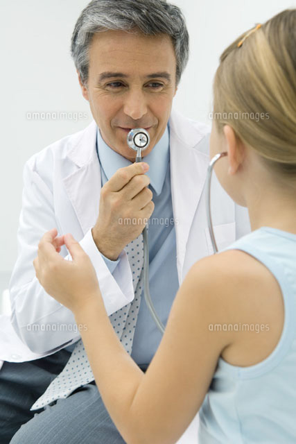 Pediatrician talking into stethoscope, girl listening
(c)Odilon Dimier/PhotoAlto