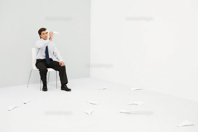 Man sitting in corner, throwing paper airplanes
(c)Ale Ventura/PhotoAlto