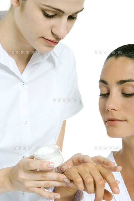 Beautician applying moisturizer to woman’s hand
(c)Alix Minde/PhotoAlto