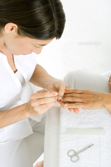 Beautician giving a manicure of woman’s hand
(c)Alix Minde/PhotoAlto