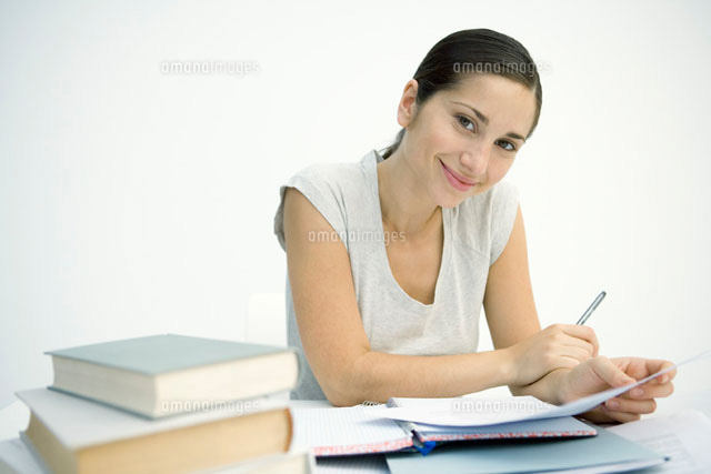 Woman working at table, holding pen and paper
(c)Sigrid Olsson/PhotoAlto