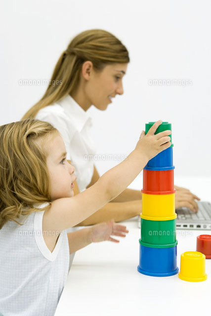Young girl stacking multi-colored cylinders
(c)Sigrid Olsson/PhotoAlto