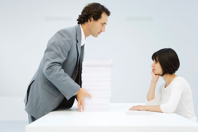 Businessman sliding tall stack of paper
(c)Alix Minde/PhotoAlto