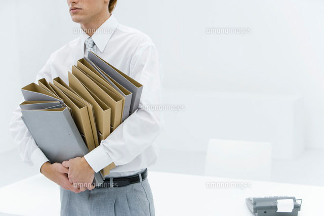 Office worker carrying many binders
(c)Alix Minde/PhotoAlto