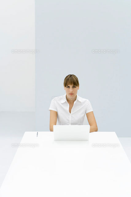 Woman sitting at table with laptop, looking at camera
(c)Alix Minde/PhotoAlto