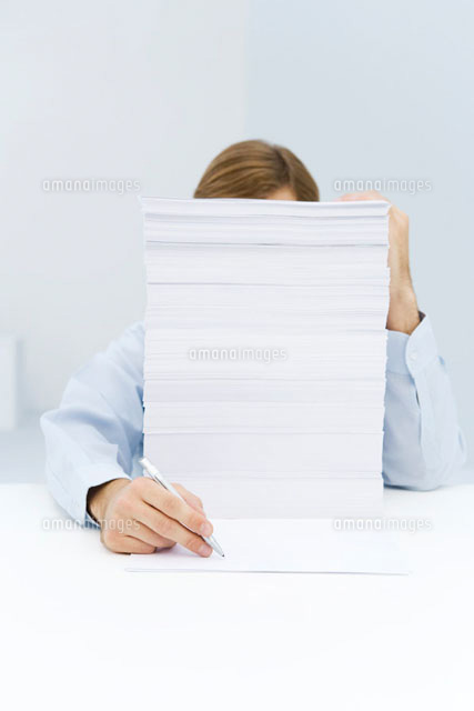 Man hiding behind tall stack of paper
(c)Alix Minde/PhotoAlto