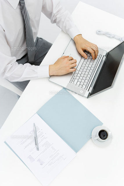 Man using laptop on desk, high angle cropped view
(c)Alix Minde/PhotoAlto