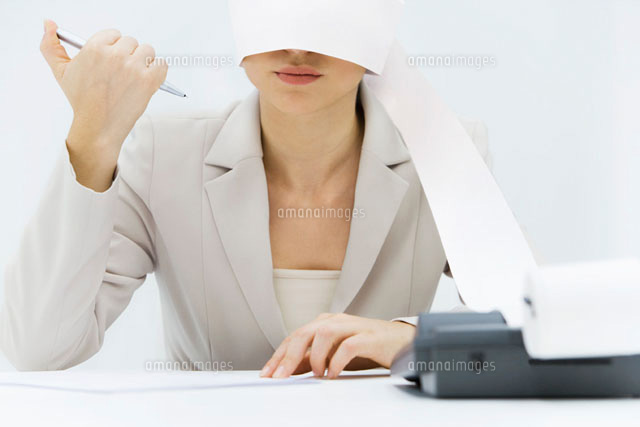 Woman sitting at desk with adding machine tape wrapped
(c)Alix Minde/PhotoAlto