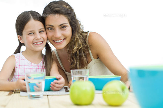 Mother and daughter sitting cheek to cheek at table
(c)Eric Audras/PhotoAlto