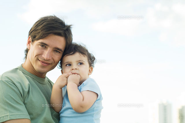 Father holding baby, smiling at camera
(c)Eric Audras/PhotoAlto