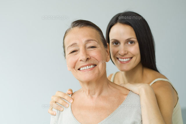 Woman behind senior mother, hands on shoulders,
(c)Eric Audras/PhotoAlto