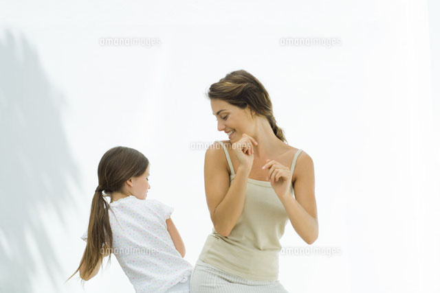 Mother dancing with daughter, bumping hips together
(c)Eric Audras/PhotoAlto