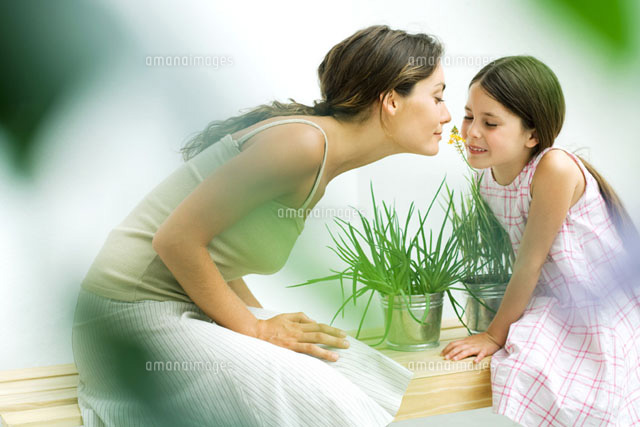Woman and daughter smelling flower sprig together
(c)Eric Audras/PhotoAlto