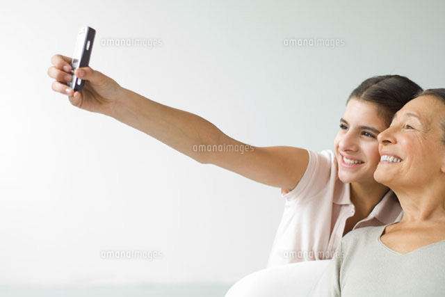 Teenage girl photographing self and grandmother
(c)Eric Audras/PhotoAlto
