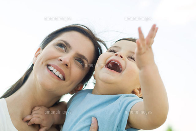 Mother holding baby, both looking up and smiling
(c)Eric Audras/PhotoAlto