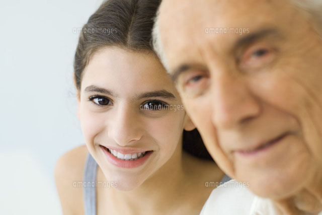 Teen girl looking over grandfather’s shoulder
(c)Eric Audras/PhotoAlto