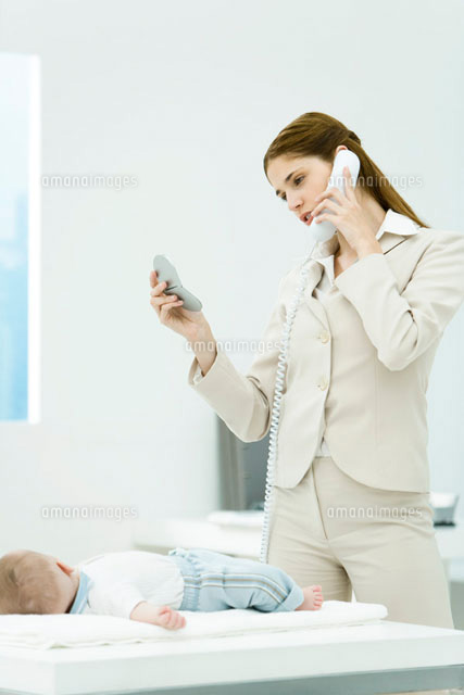 Professional woman talking on phone, looking at self
(c)Alix Minde/PhotoAlto