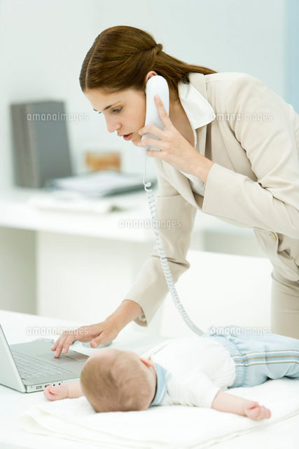 Professional woman using phone and laptop computer
(c)Alix Minde/PhotoAlto