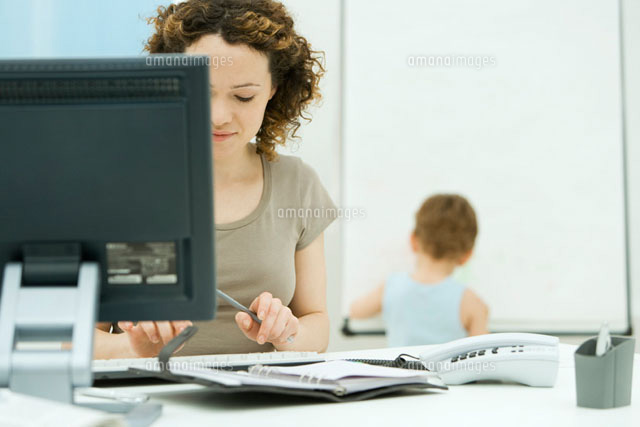 Woman working at computer in home office, young son playing
(c)Alix Minde/PhotoAlto